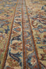 Load image into Gallery viewer, Close-up of an ornate patterned rug with beige, blue, and brown floral and scroll motifs.