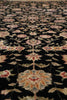 Load image into Gallery viewer, A close-up of an ornate floral patterned rug with a black background and cream, pink, and muted blue motifs.