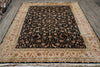 Load image into Gallery viewer, A rectangular area rug with a black central field covered in dense floral motifs, surrounded by a wide beige border with matching floral patterns, photographed from above on a gray floor.
