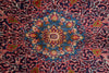 Load image into Gallery viewer, A close-up of a traditional patterned rug featuring a central medallion in shades of blue, red, pink, cream, and green, surrounded by an intricate floral and geometric border.