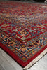 Load image into Gallery viewer, A traditional oriental area rug with a deep red field, detailed floral motifs, and cream fringe.