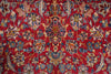 Load image into Gallery viewer, A close-up of a traditional patterned rug with a vibrant red background and intricate floral motifs in blue, beige, and gold.