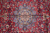 Load image into Gallery viewer, A close-up of a traditional Persian-style rug with a vibrant red background and an intricate central medallion pattern in blue, beige, and cream.