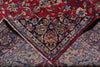 Load image into Gallery viewer, A close-up of an ornate patterned rug with a deep red field, dark navy central panel, and beige lower section, all decorated with intricate floral and vine motifs in blue, cream, and rust tones.