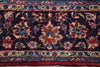 Load image into Gallery viewer, A close-up of a traditional patterned rug with a dark navy blue field, featuring intricate floral motifs in red, beige, blue, and green, bordered by detailed geometric and floral bands.