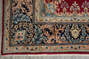 Load image into Gallery viewer, Close-up of an ornate patterned rug corner showing a dark navy field with beige and blue floral motifs, a red border, and cream detailing.