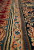 Load image into Gallery viewer, Close-up of a patterned area rug with ornate floral and geometric motifs in red, blue, beige, and brown tones.