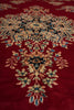 Load image into Gallery viewer, A close-up of a traditional oriental rug featuring a deep red background with an intricate floral and medallion pattern in beige, blue, and black.