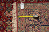 Load image into Gallery viewer, A close-up of an ornate patterned rug with cream fringe, shown with a yellow tape measure and a white size tag to indicate dimensions.