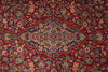 Load image into Gallery viewer, A close-up of a traditional Persian-style area rug featuring a rich red background with an intricate central medallion and floral motifs in beige, blue, and green.