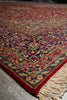 Load image into Gallery viewer, A close-up of a traditional patterned rug with cream fringe, featuring a red border and an intricate central design in red, blue, beige, and green tones.