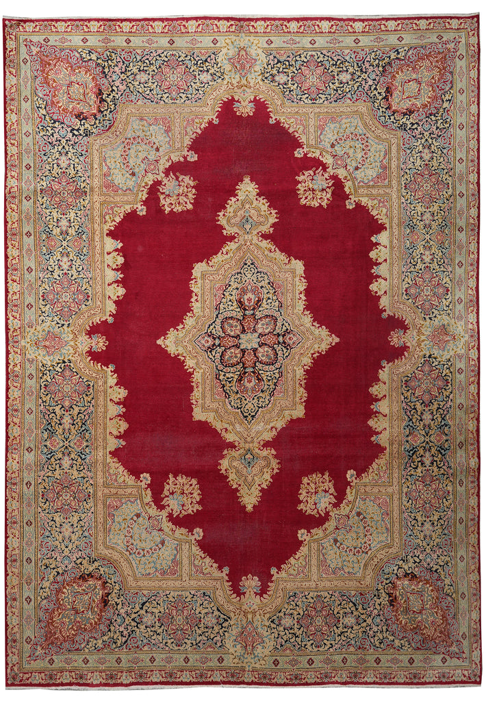 A traditional oriental area rug with a deep red central field, beige and cream borders, and intricate floral motifs in muted green, blue, and pink.