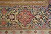 Load image into Gallery viewer, A close-up of an ornate traditional rug with a central floral medallion and intricate scrolling patterns in beige, navy, red, light blue, and gold.