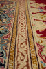 Load image into Gallery viewer, Close-up of an ornate patterned rug showing detailed woven bands in cream, burgundy, gold, blue, and red.