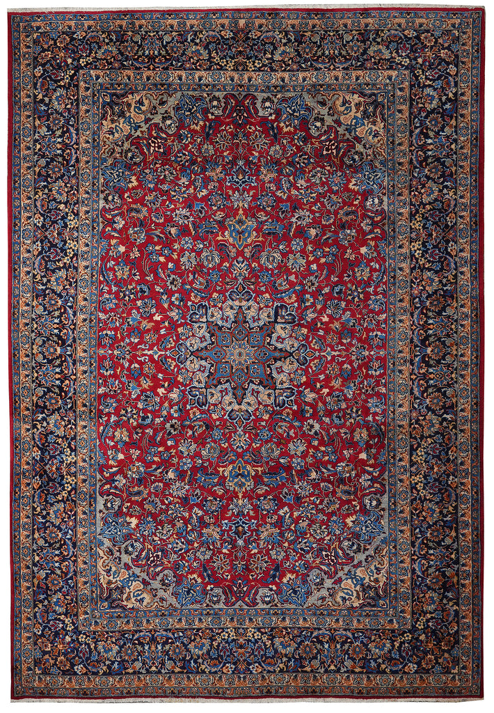 A traditional oriental area rug with a deep red central field, intricate floral motifs, and a dark navy blue border with beige and cream details.