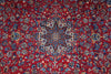 Load image into Gallery viewer, A close-up of a traditional Persian-style rug with a vibrant red background, featuring an intricate central medallion and dense floral motifs in blue, beige, and white.