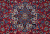 Load image into Gallery viewer, A close-up of a traditional Persian-style rug featuring a vibrant red field with an intricate central medallion and floral motifs in blue, beige, and brown.