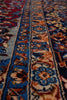 Load image into Gallery viewer, Close-up of an ornate patterned rug with floral motifs in blue, red, beige, and brown tones.