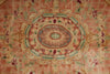 Load image into Gallery viewer, A close-up of a traditional oriental rug featuring a central oval medallion and surrounding floral motifs in muted pink, beige, sage green, and terracotta.
