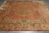 Load image into Gallery viewer, A large rectangular area rug with an ornate medallion pattern in muted terracotta, beige, and sage green tones, laid flat on a gray wood floor.