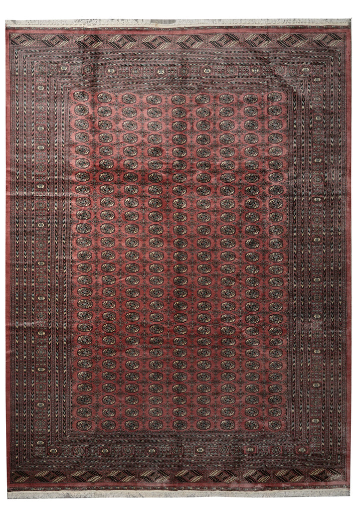 A traditional oriental rug with a dusty rose red field, dark brown borders, and intricate circular motifs in black and muted green.