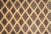 Load image into Gallery viewer, A close-up of a patterned textile or rug showing a repeating diamond motif in beige, brown, and muted blue tones.