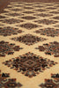 Load image into Gallery viewer, A close-up of a patterned rug with repeating diamond motifs in beige, brown, black, and muted blue-gray tones.