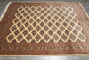 Load image into Gallery viewer, A rectangular area rug with a traditional Persian-style geometric lattice pattern in beige, brown, and rust red, laid flat on a gray tiled floor.