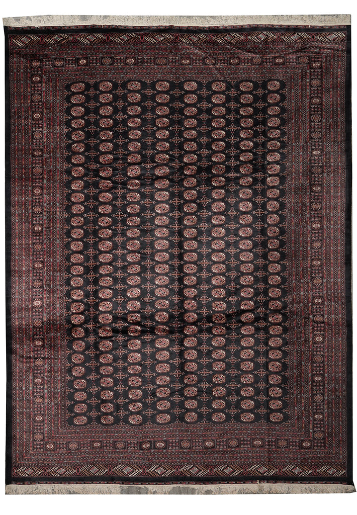 A rectangular area rug with a traditional Persian-style pattern, featuring a dark central field with repeating circular motifs and a wide burgundy border with fringe on the top and bottom edges.