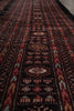 Load image into Gallery viewer, A close-up view of a patterned rug showing detailed woven geometric and floral motifs in dark red, black, brown, and cream.