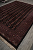 Load image into Gallery viewer, A traditional Persian-style area rug with a dark red and black background, featuring circular medallion motifs and a beige fringed edge, shown laid out on a gray tiled floor.