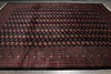 Load image into Gallery viewer, A large rectangular area rug with a dark black field, featuring rows of repeating circular medallion motifs in red and brown, and a detailed patterned border.