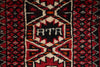 Load image into Gallery viewer, A close-up of a patterned rug featuring a central geometric motif with the letters 'RTA' in white on a black background, surrounded by red, black, and cream patterns.