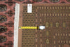Load image into Gallery viewer, A patterned area rug with a dusty rose and brown geometric design, featuring white fringe on one side. A yellow tape measure is laid horizontally across the rug to show its dimensions, and a white product tag is visible near the top.