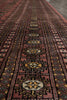 Load image into Gallery viewer, A close-up view of a patterned area rug with a dusty rose and dark brown base, featuring traditional geometric motifs in black, yellow, and cream.