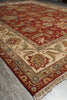 Load image into Gallery viewer, A traditional oriental area rug with a deep red field, beige border, and intricate floral motifs in blue, green, and gold, shown on a gray tiled floor.
