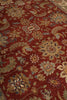 Load image into Gallery viewer, A close-up of an ornate area rug with a deep red background and intricate floral motifs in beige, blue, and green.