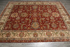 Load image into Gallery viewer, A rectangular traditional area rug with an intricate floral and medallion pattern, featuring a deep red center field, beige borders, and accents of blue and green, laid out on a gray tiled floor.