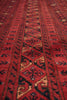 Load image into Gallery viewer, A close-up of a red patterned rug with geometric and tribal-style motifs in black, beige, and brown.