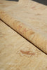 Load image into Gallery viewer, A close-up of a rolled beige stone or marble-look material with natural tan and reddish-brown veining, shown against a matching flat surface.