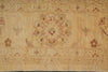 Load image into Gallery viewer, A close-up of a vintage-style area rug with a central medallion and floral motifs in warm beige, tan, and muted reddish-brown tones.