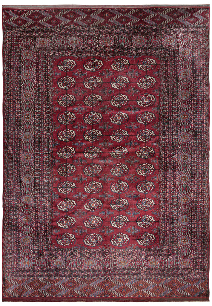 A traditional oriental area rug with a deep red central field featuring repeating circular medallion motifs, surrounded by a wide dusty mauve-purple border and patterned corners.