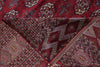Load image into Gallery viewer, A close-up of a patterned area rug with deep red, navy, beige, and brown geometric and floral motifs.