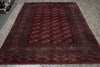 Load image into Gallery viewer, A traditional Persian-style area rug with a deep red field, intricate geometric borders, and repeating medallion motifs in beige, brown, and blue, laid out on a gray wood floor.