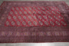 Load image into Gallery viewer, A large traditional Persian-style area rug with a deep red field, featuring rows of circular medallions and detailed geometric borders, laid flat on a light gray tiled floor.