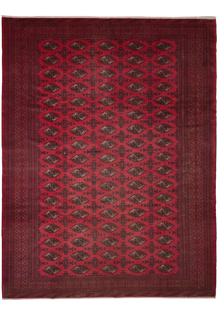 A rectangular area rug with a deep red border and central field, featuring a repeating pattern of dark brown and black medallions on a red background.