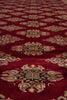 Load image into Gallery viewer, A close-up of a red patterned rug with ornate medallion motifs in beige, brown, and muted blue-gray.