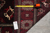 Load image into Gallery viewer, A close-up of a patterned area rug with a measuring tape and a price tag placed on top, showing the rug's design and dimensions against a gray tile floor.