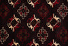 Load image into Gallery viewer, A close-up of a woven textile with a repeating geometric pattern in dark red, cream, and black on a very dark background.