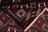 Load image into Gallery viewer, A close-up of a patterned rug showing deep red, burgundy, cream, and brown geometric and floral motifs with a fringed edge.